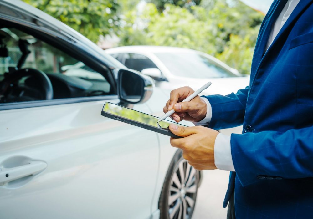 businessman in suit and car auto insurance agent assess car damage, discussing deductible, claims